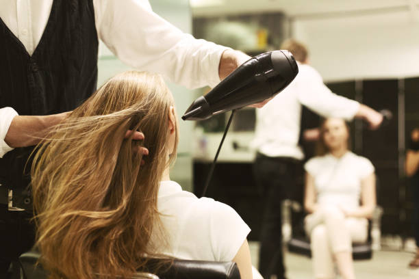 stylist-drying-girls-hair-with-hair-dryer-in-beauty-salon.jpg