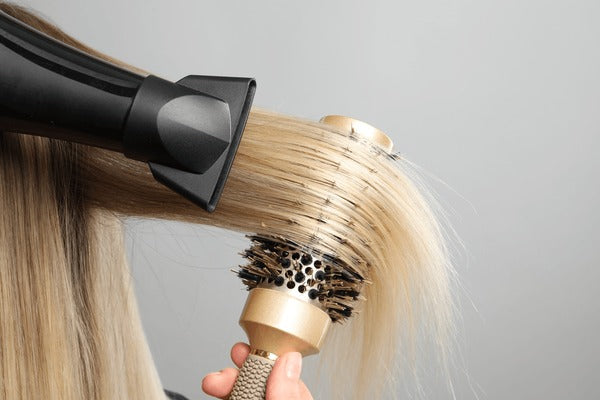hairdresser-blow-drying-clients-hair-600nw-2426959477.jpg
